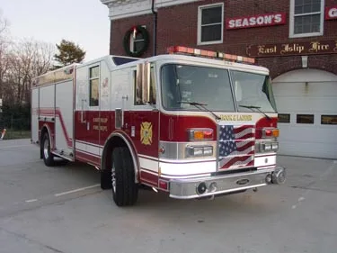 Rescue truck front-left view showing grille, bumper, and side compartments
