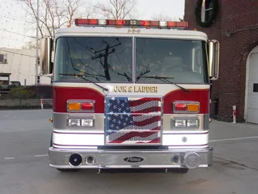Front exterior view showing grille, bumper, and warning lights