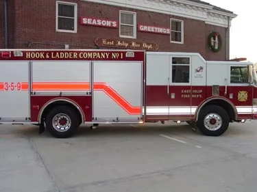 Driver-side profile view showing long rescue body and side compartments