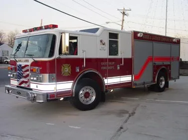 Front-left exterior view showing bumper, cab, and side compartments