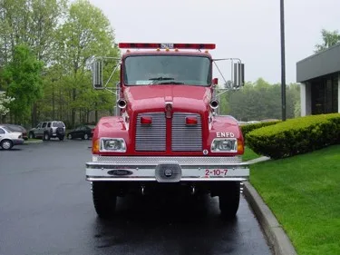 Front exterior view showing grille, bumper, and warning lights