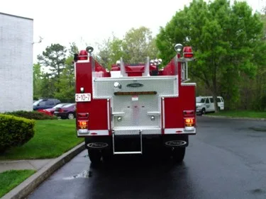 Rear view showing rear panel, warning lights, and lower step