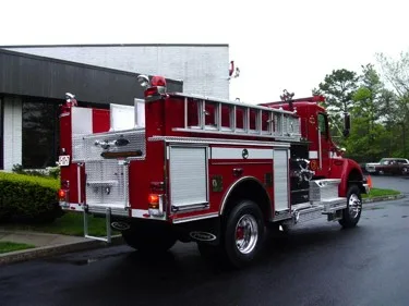 Rear-right exterior view showing side hosebed rails and rear body