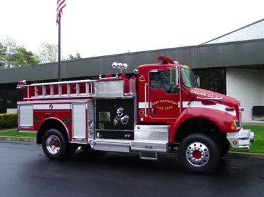 Driver-side profile with open pump panel showing gauges and controls