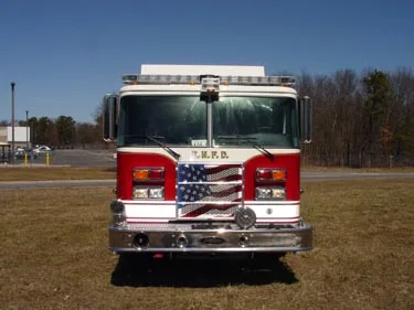Front exterior view showing grille, bumper, and warning lights