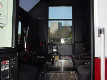 Rear crew cab interior view showing bench seats and center aisle