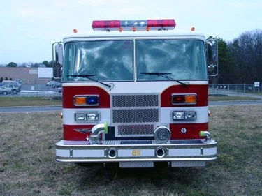 Front exterior view showing grille, bumper, and warning lights