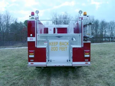 Rear view showing rear body panel, warning lights, and hosebed area