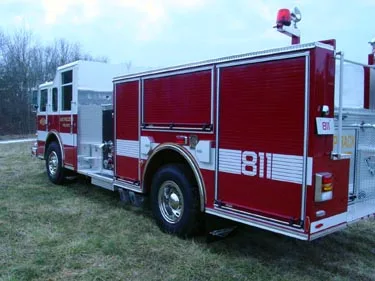 Rear-right exterior view showing side compartments and rear wheel area