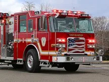 Pumper front-left exterior view showing enclosed cab and side compartments