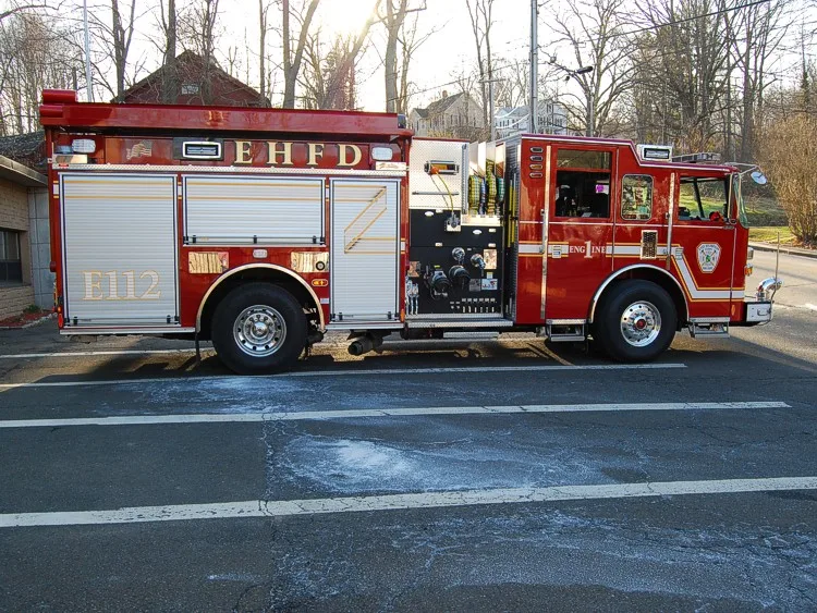 Driver-side profile view showing pump panel area and side compartments