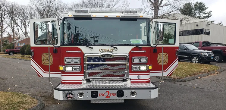 Head-on front view showing grille, bumper, and warning lights