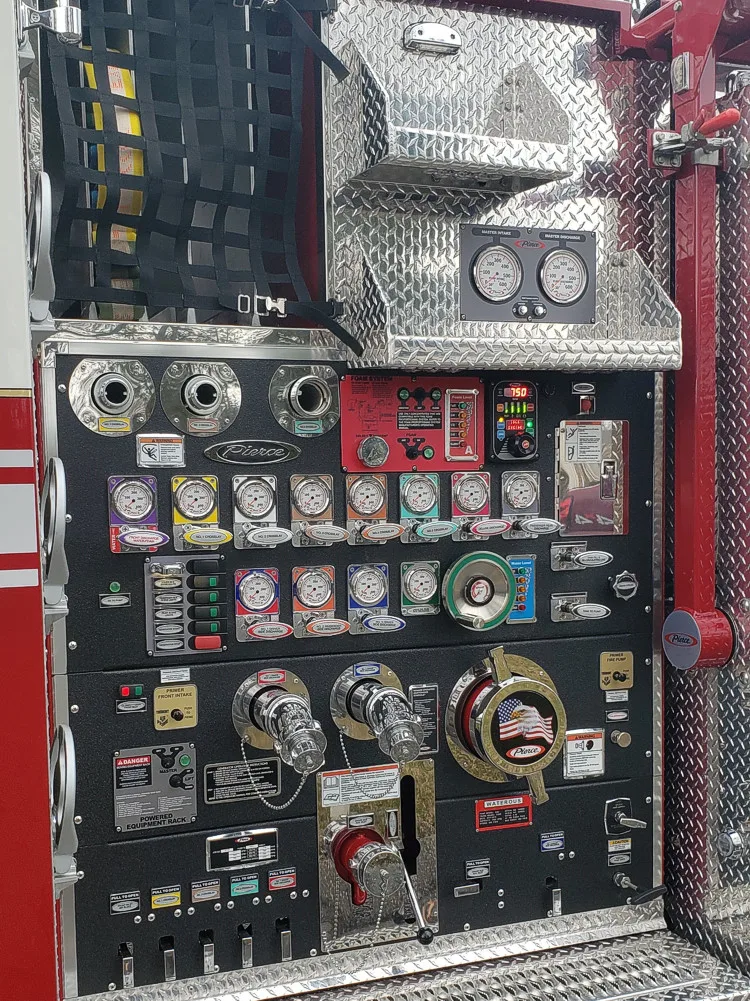 Pump panel close-up showing gauges, valves, and intake controls