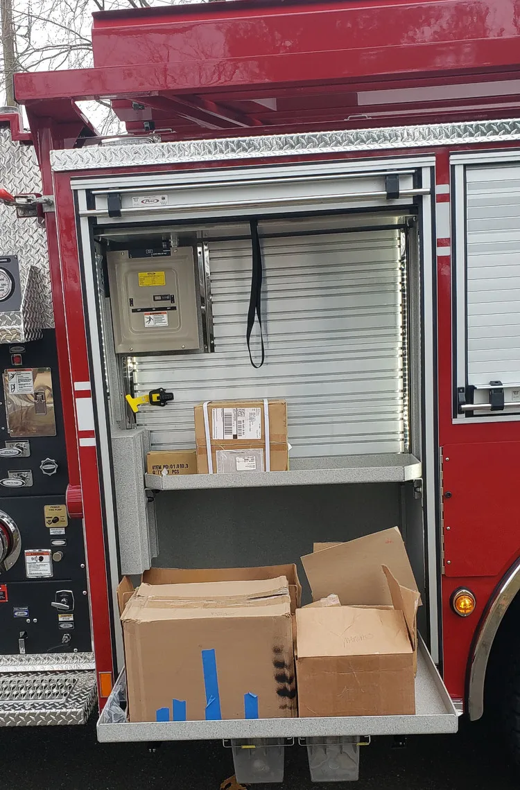 Open side compartment showing cardboard boxes on lower shelf