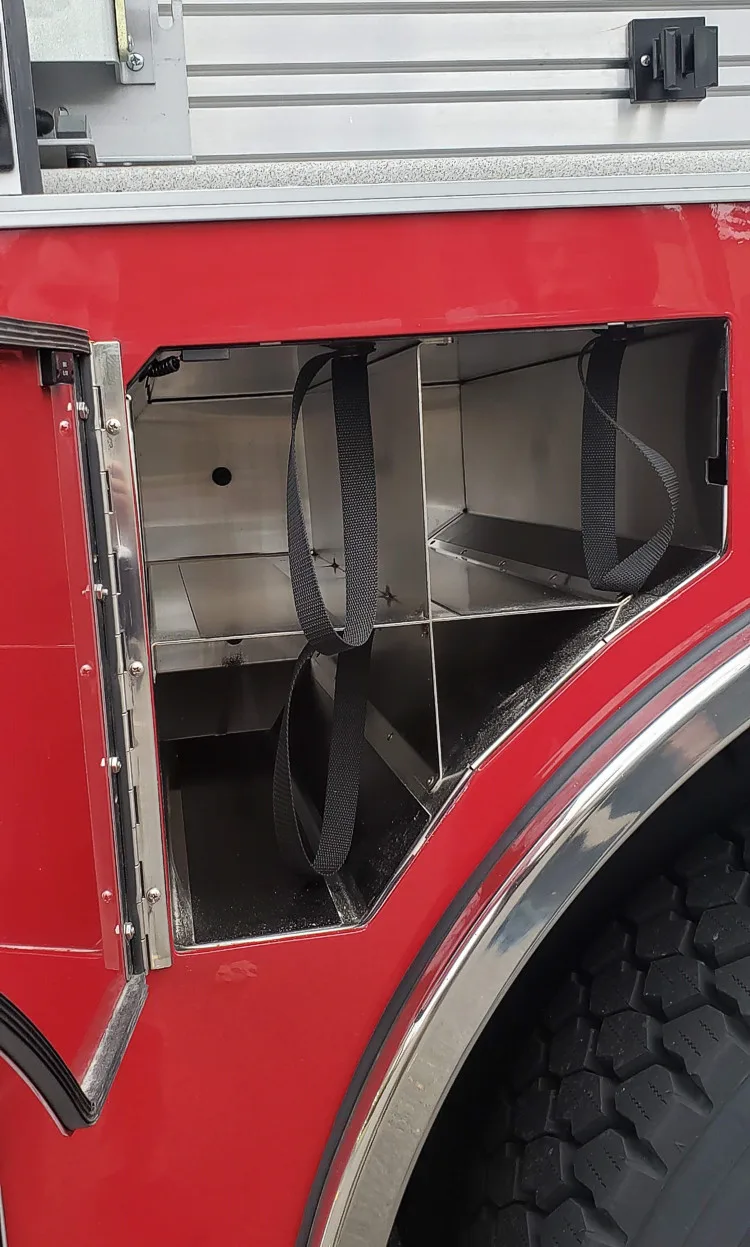 Open lower body compartment showing wheel-well cutout and empty bay