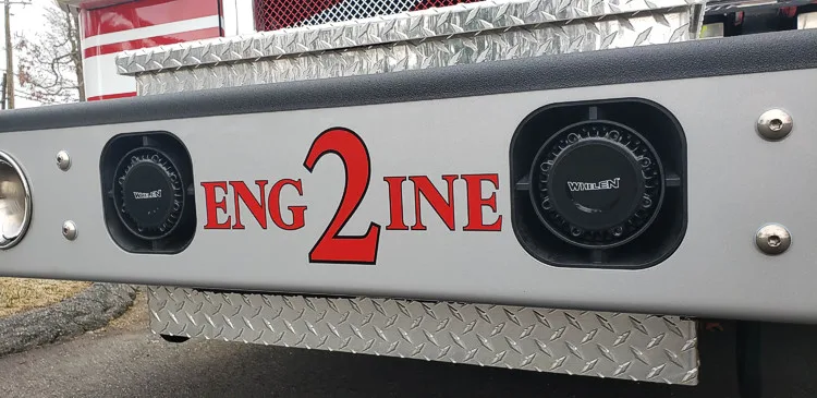 Body side close-up showing raised engine lettering and side panel trim