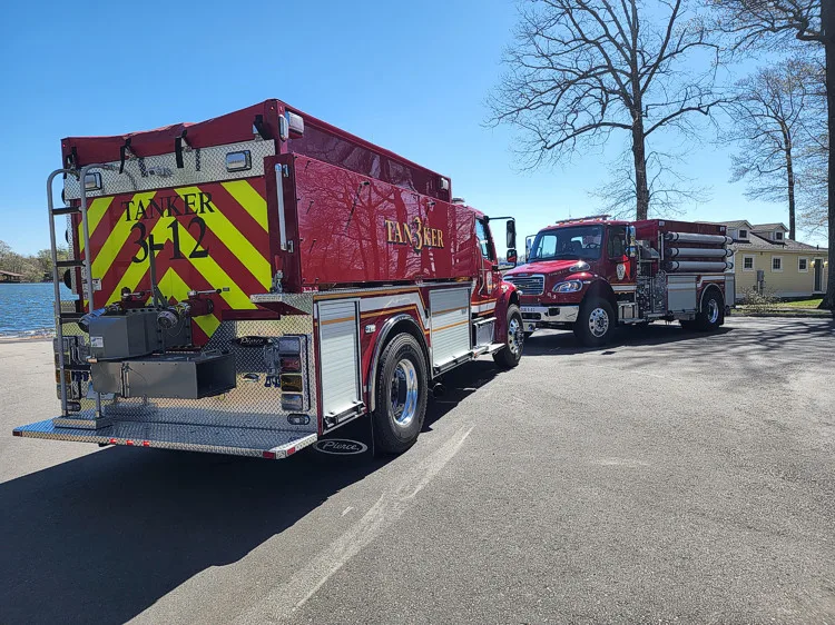 Rear-left exterior view showing side tank body and rear chevrons
