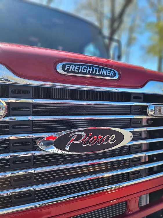 Front grille close-up showing Freightliner badge and chrome bars