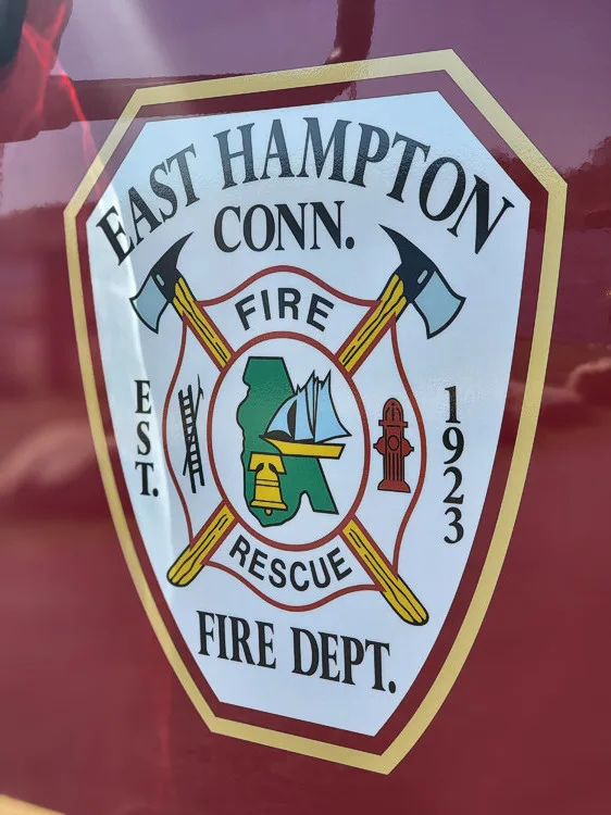 Cab door close-up showing shield-style fire department crest