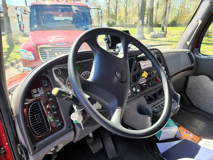 Driver cockpit view showing steering wheel, gauges, and center controls