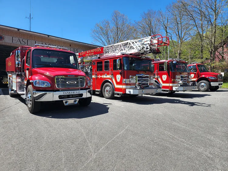 Apparatus lineup view showing tanker parked with additional trucks outdoors