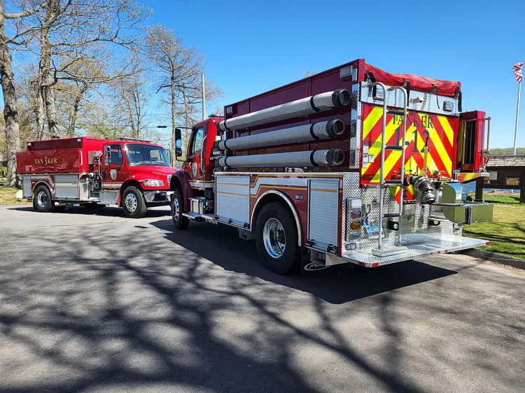 Rear-left exterior view showing tank body and rear chevron striping
