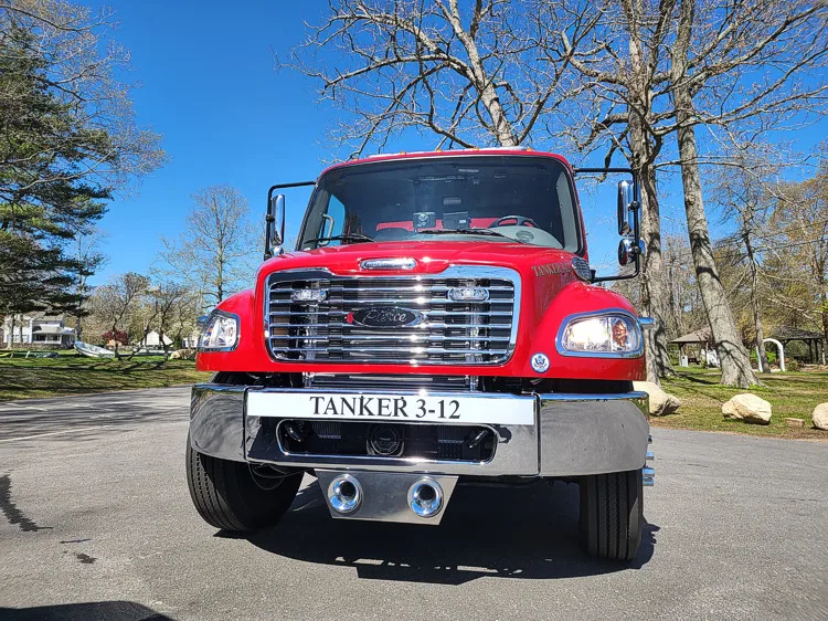 Head-on front view showing grille, bumper, and warning lights