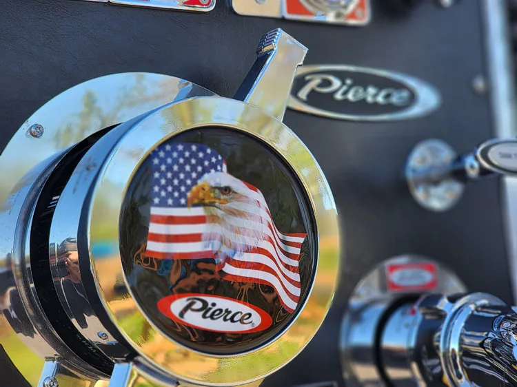 Front grille badge close-up showing Pierce emblem with patriotic insert