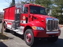 Tanker front-left exterior view showing commercial-style cab and long tank body
