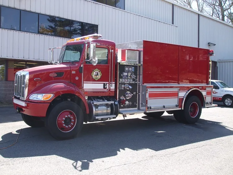 Driver-side profile view showing side tank body and pump panel area