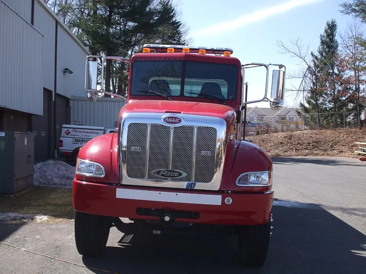 Front exterior view showing grille, bumper, and warning lights