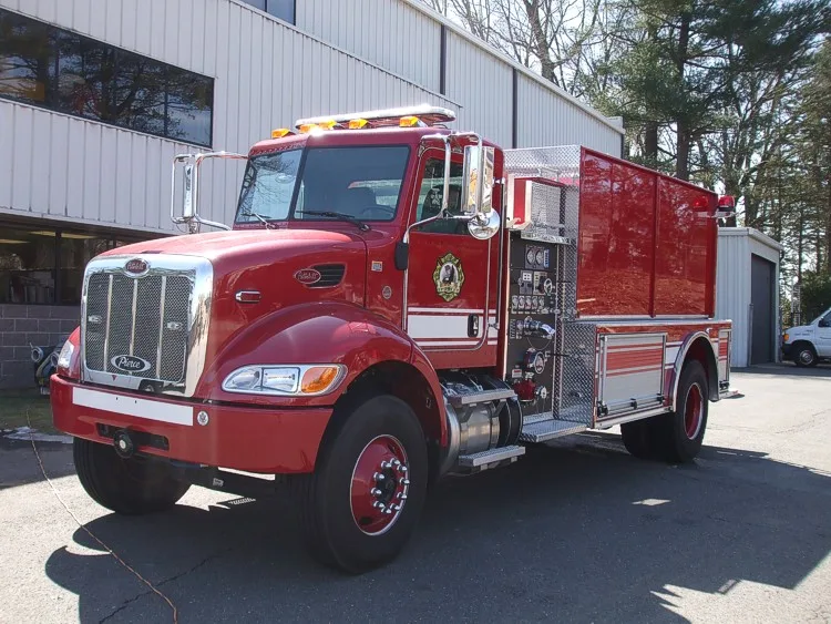 Front-left exterior view showing bumper, cab, and tank body