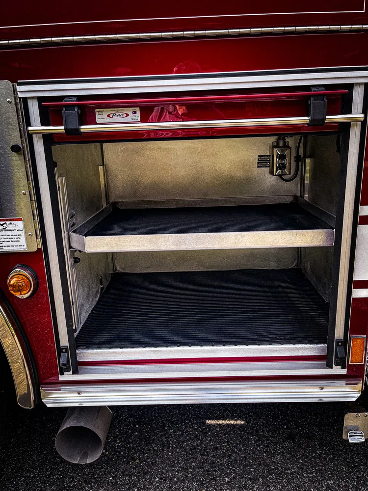 Open side compartment showing empty shelf bay and lower storage space