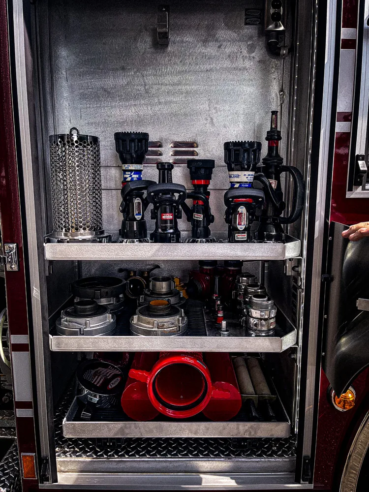 Open side compartment showing stacked bins and equipment containers