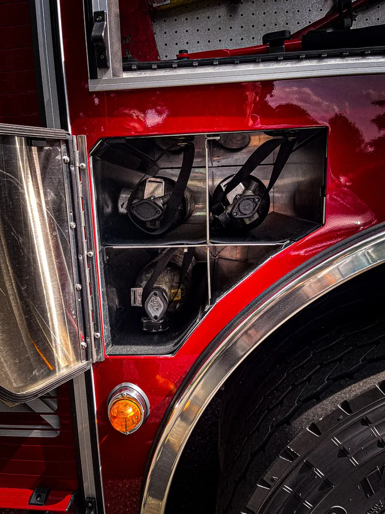 Open side compartment showing wheel-well bay and adjacent shelf storage