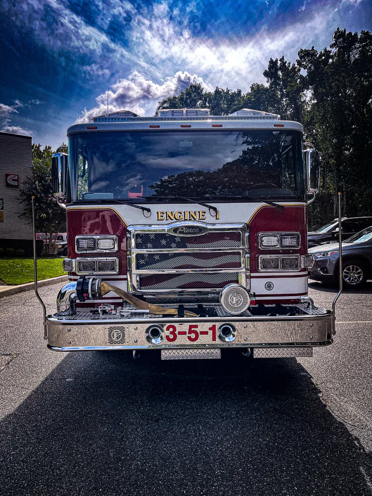 Head-on front view showing grille, bumper intake, and warning lights