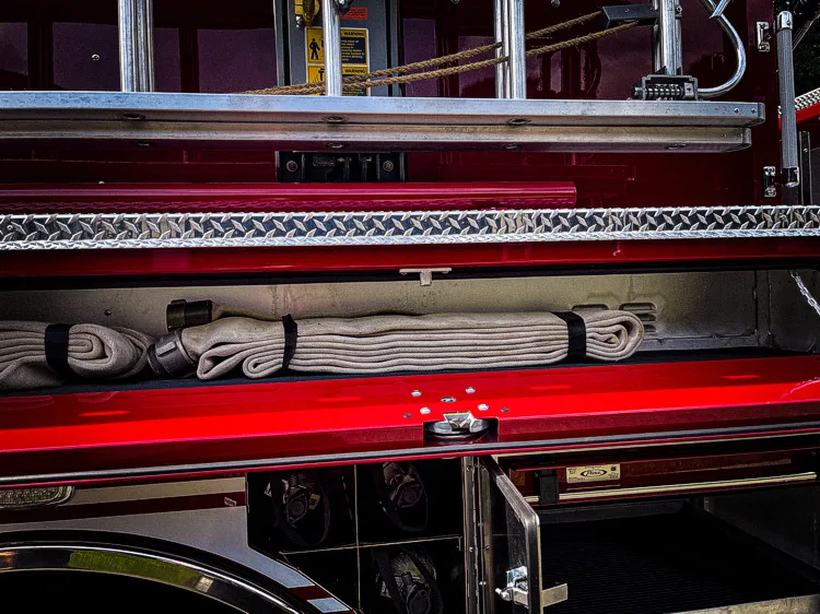 Open side body close-up showing mounted long tools in horizontal rack