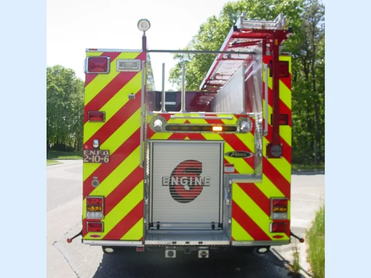 Rear view showing chevron striping, rear body panel, and hosebed area