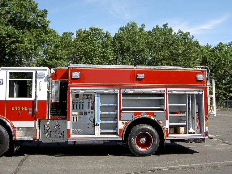 Passenger-side profile with open compartments showing storage shelves and tools