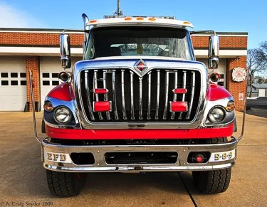 Front view of rescue pumper showing grille, bumper, and warning lights