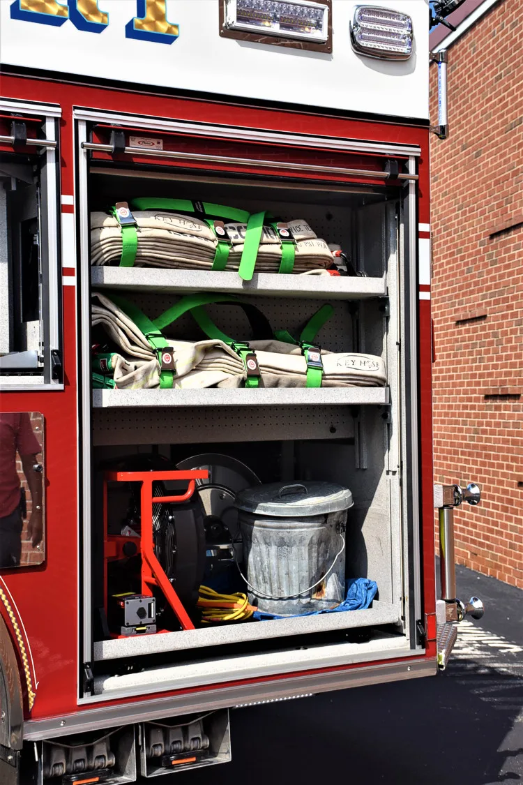 Open side compartment showing shelves with bags and utility gear