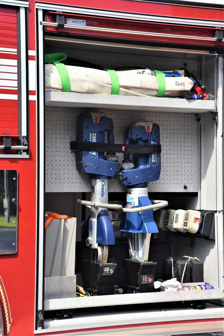 Open side compartment showing mounted nozzles and tool storage racks