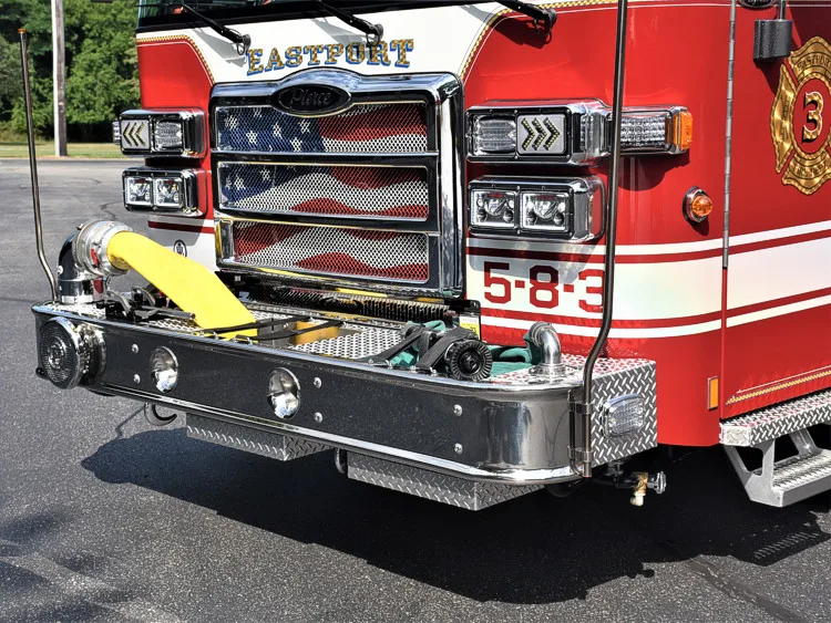 Front bumper close-up showing intake ports, warning lights, and unit number