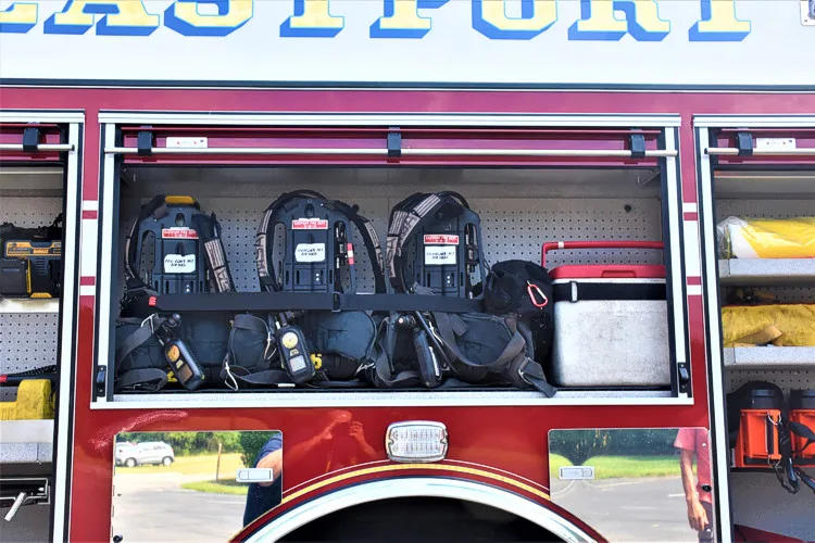 Open side compartment showing mounted SCBA packs and gear brackets