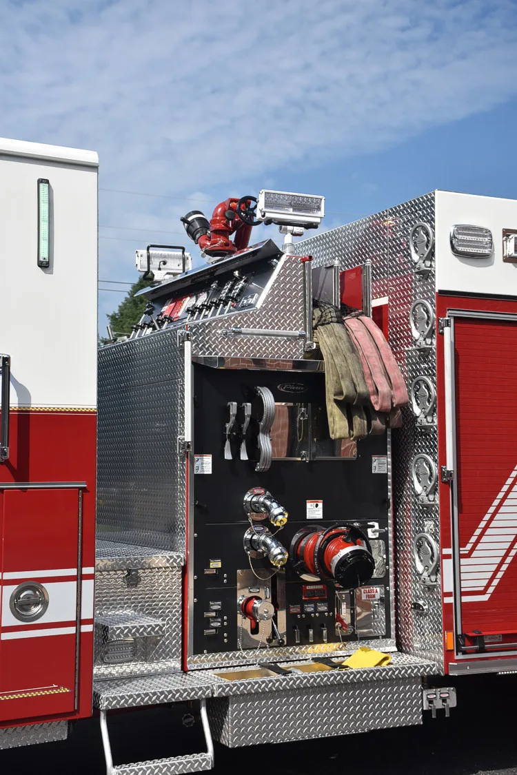 Rear-left compartment view showing mounted tools and open side panel