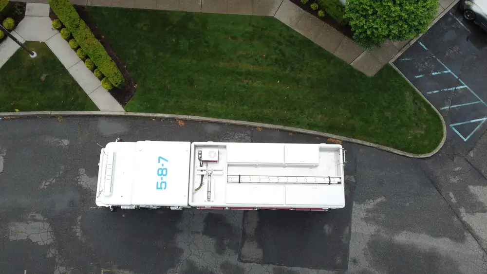 Aerial top-down side view showing full apparatus length and compartments