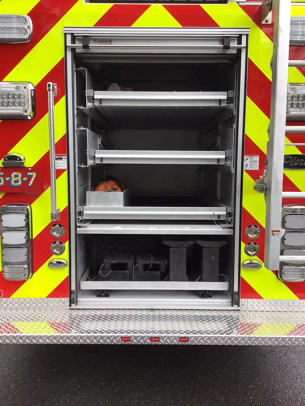 Rear compartment open showing slide-out shelves and storage trays