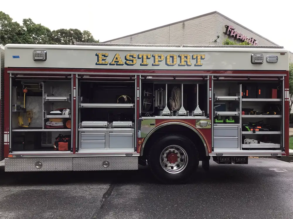 Driver-side mid-body compartment bank open with shelves and drawers