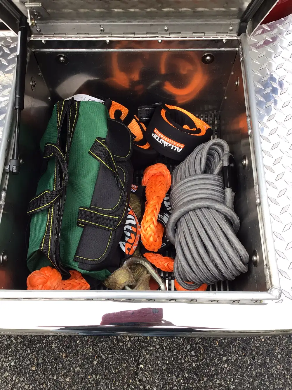 Open utility bin showing rope bags and recovery line