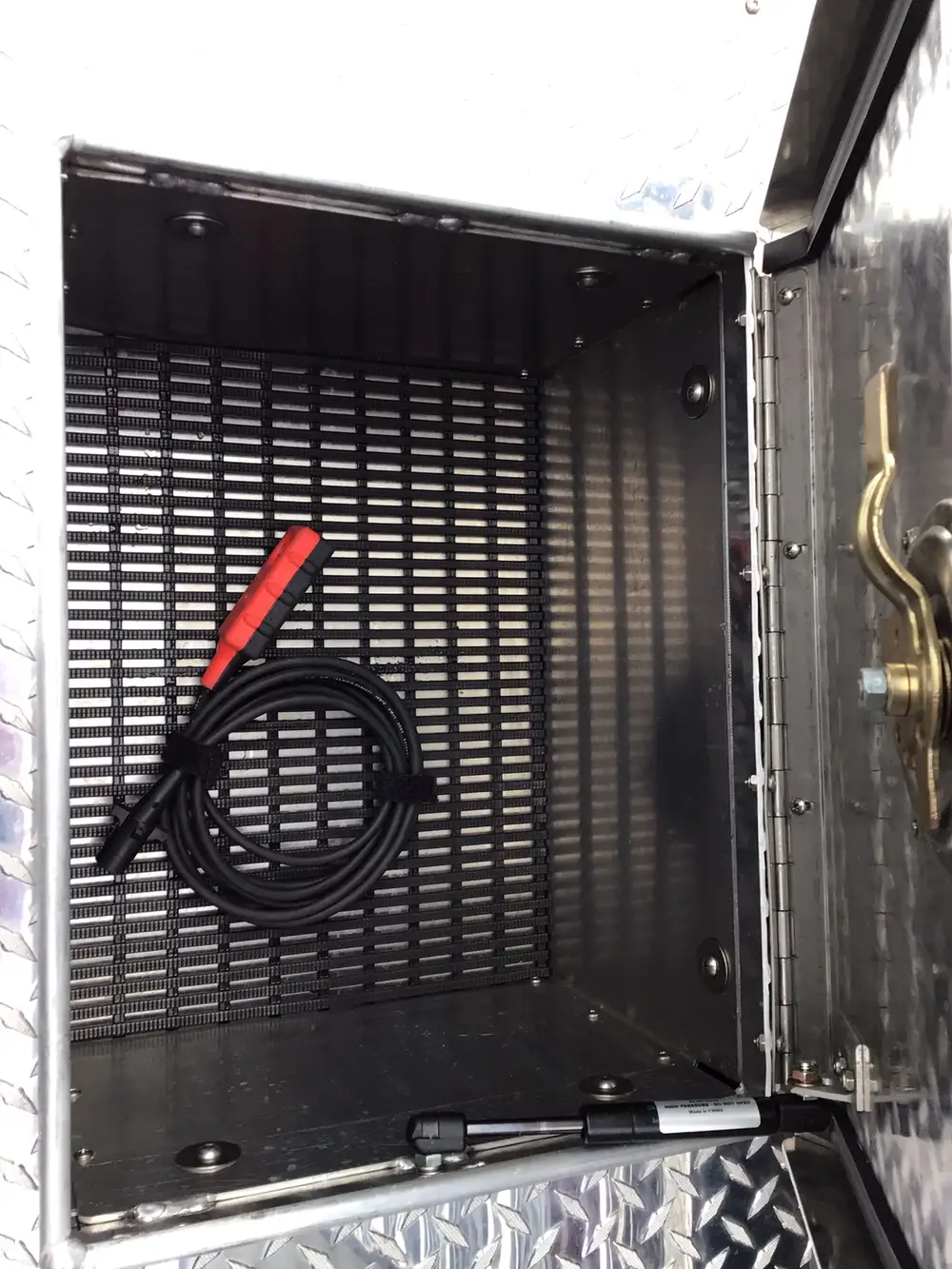 Narrow vertical compartment with mounted rope bag and hand tool